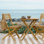 Table pliante en teck naturel avec chaises bistrot
