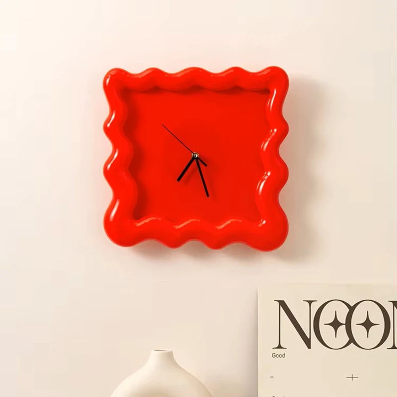 Horloge ondulée rouge accrochée au mur, design original et tendance.