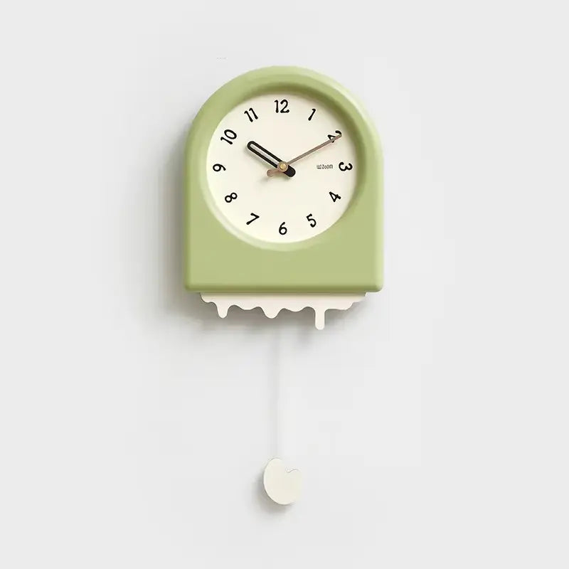 Horloge à pendule moderne verte avec un effet fonte et un pendule décoratif en forme de goutte suspendue.