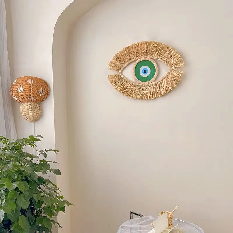 Oeil décoratif mural vert en paille naturelle, pour un intérieur chaleureux